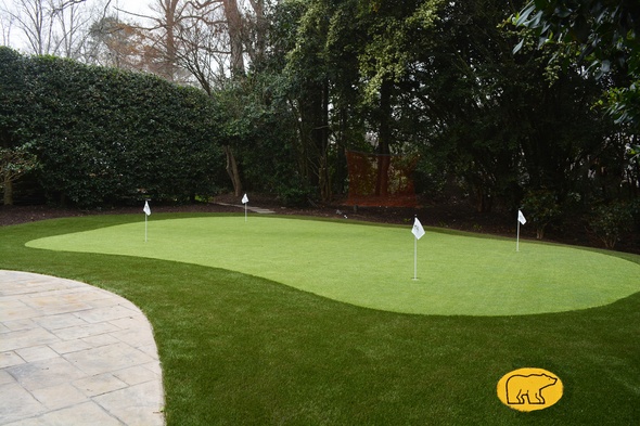 Huntsville Synthetic grass golf green with 4 holes and flags in a landscaped backyard