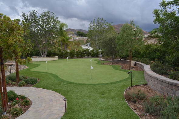 Huntsville Synthetic grass golf green in a landscaped backyard