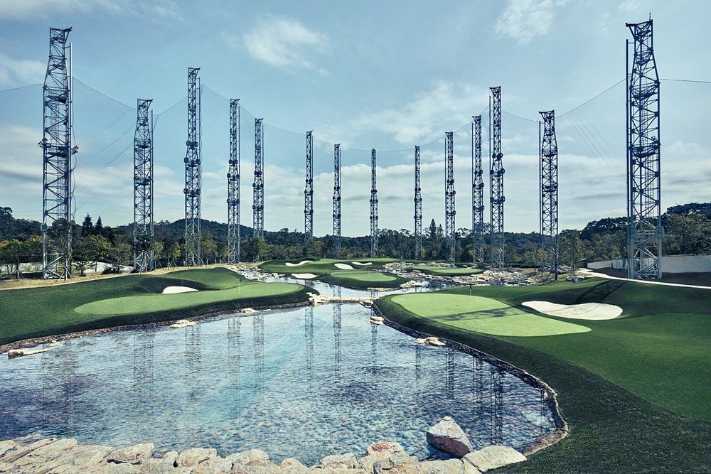 Huntsville Synthetic grass golf course with water and tall metal towers