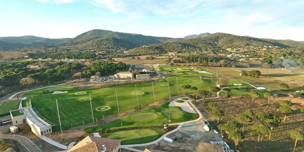 Huntsville Aerial view of a synthetic grass golf course surrounded by hills